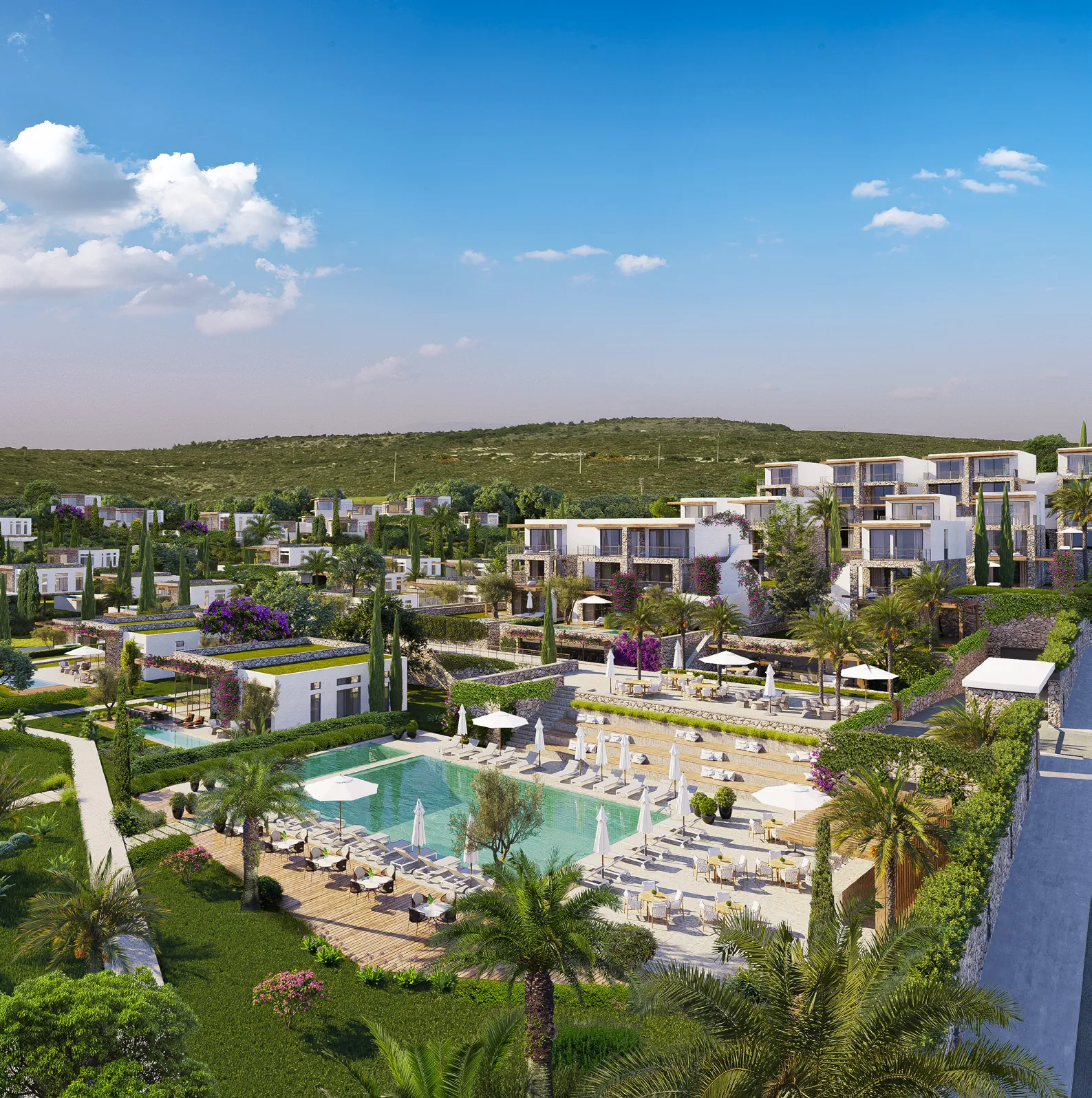 Aerial view of a hillside resort with villas and a swimming pool