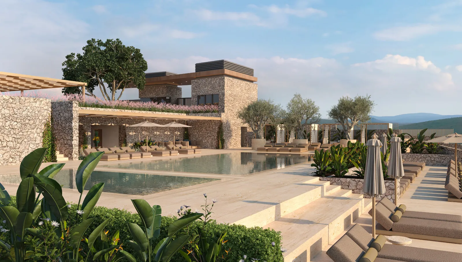 Resort pool terrace with stone buildings and olive trees